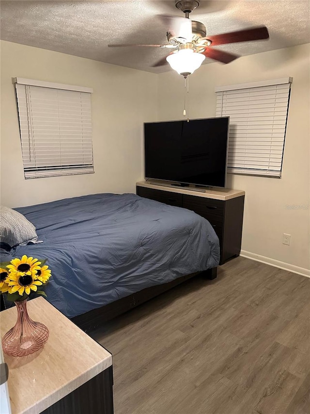 2902 Little Rd, Valrico, FL 33596 - bedroom with baseboards, ceiling fan, wood finished floors, and a textured ceiling