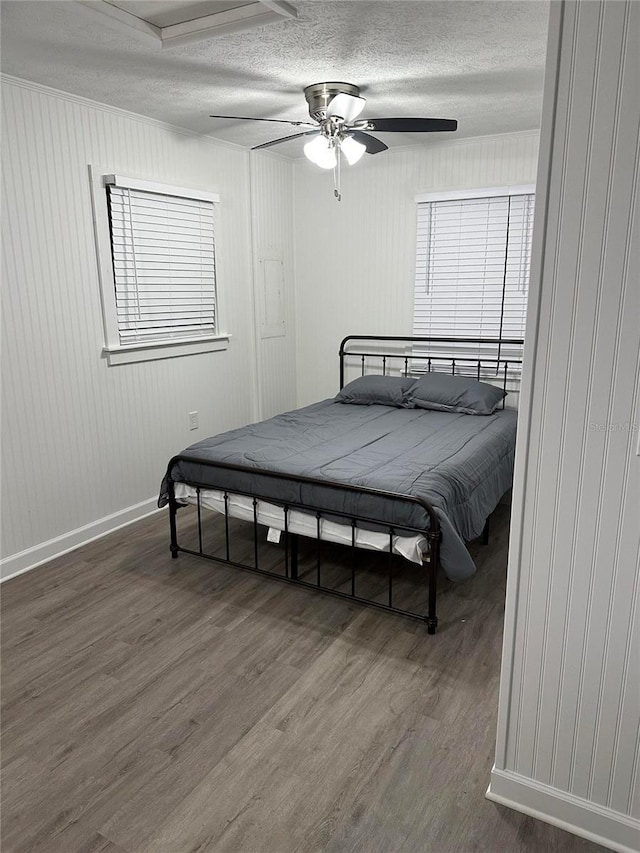 2902 Little Rd, Valrico, FL 33596 - bedroom featuring baseboards, a textured ceiling, a ceiling fan, and wood finished floors