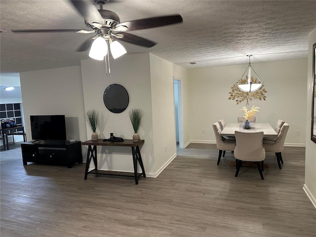 2902 Little Rd, Valrico, FL 33596 - dining room featuring a textured ceiling, wood finished floors, ceiling fan, and baseboards