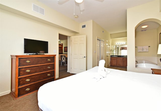 8112 Poinciana Blvd Unit 1809, Orlando, FL 32821 - bedroom featuring visible vents, connected bathroom, a closet, and arched walkways