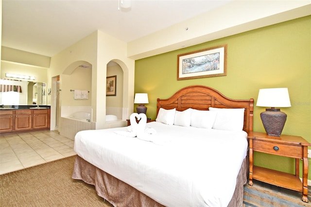 8112 Poinciana Blvd Unit 1809, Orlando, FL 32821 - bedroom featuring light tile patterned floors, light colored carpet, and ensuite bath