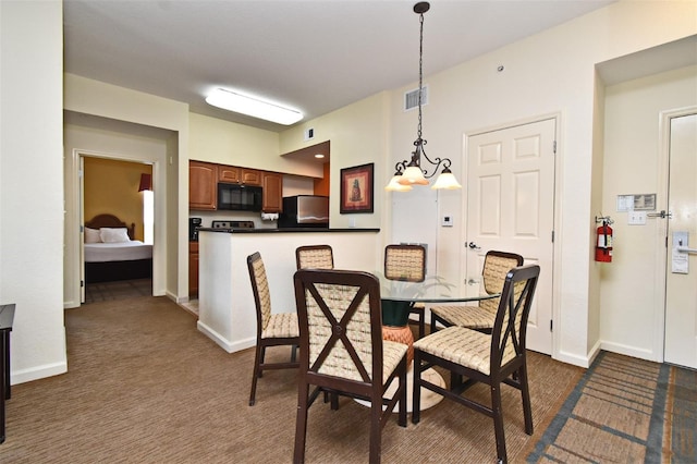 8112 Poinciana Blvd Unit 1809, Orlando, FL 32821 - dining space with dark carpet, visible vents, a notable chandelier, and baseboards