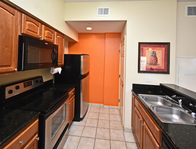 8112 Poinciana Blvd Unit 1809, Orlando, FL 32821 - kitchen with appliances with stainless steel finishes, visible vents, brown cabinetry, and a sink