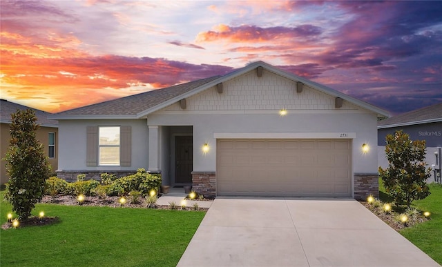 view of front of property featuring stucco siding, concrete driveway, and stone siding