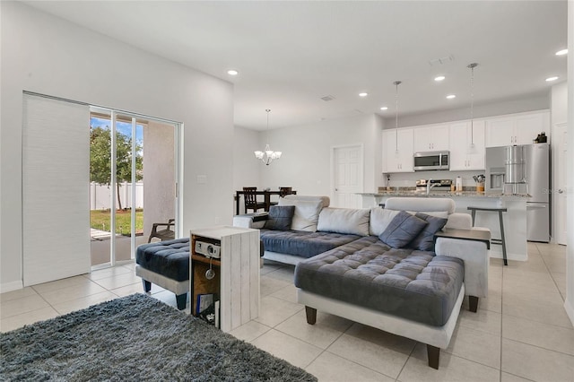 living room featuring light tile patterned floors, recessed lighting, and a chandelier