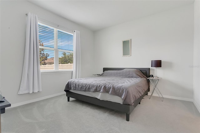 carpeted bedroom featuring baseboards