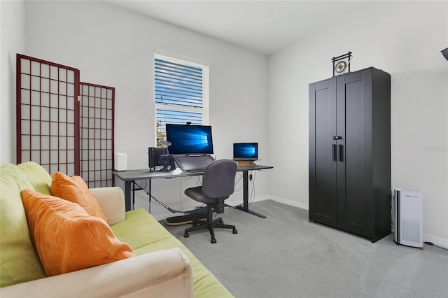 home office featuring baseboards and light carpet