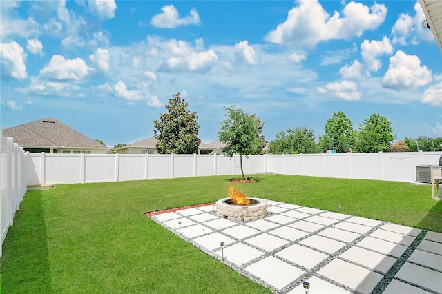 view of yard featuring a patio, a fire pit, and a fenced backyard