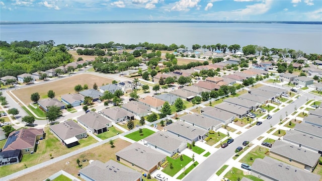 birds eye view of property featuring a water view and a residential view