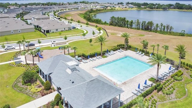 drone / aerial view with a water view and a residential view