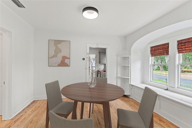 dining area featuring visible vents and light wood-style flooring