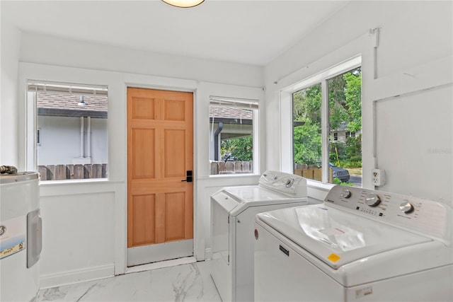 clothes washing area with baseboards, laundry area, marble finish floor, and washer and clothes dryer