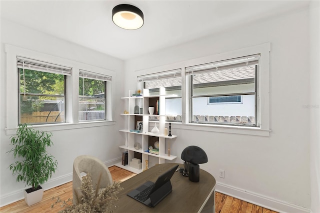 home office featuring baseboards and wood finished floors