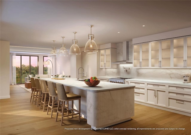 10160 Autumn Mist Ln Unit 601, Golden Oak, FL 32836 - kitchen with tasteful backsplash, a sink, wall chimney exhaust hood, and a center island with sink