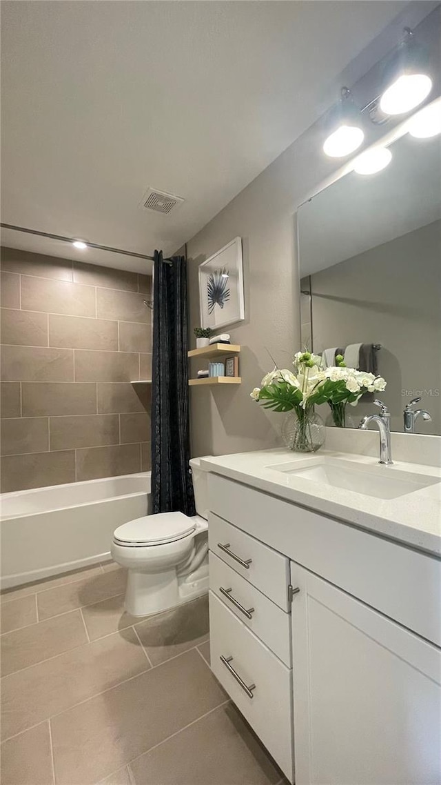 full bath with tile patterned floors, vanity, shower / tub combo, toilet, and visible vents