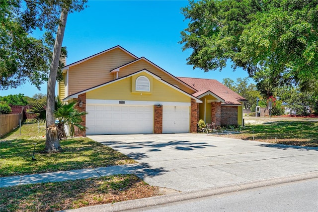 traditional-style house with concrete driveway, a garage, fence, and brick siding