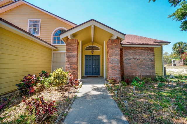 doorway to property featuring brick siding