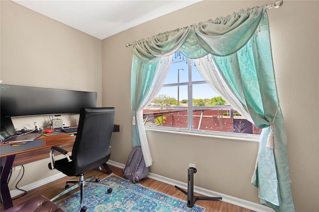 office with wood finished floors and baseboards
