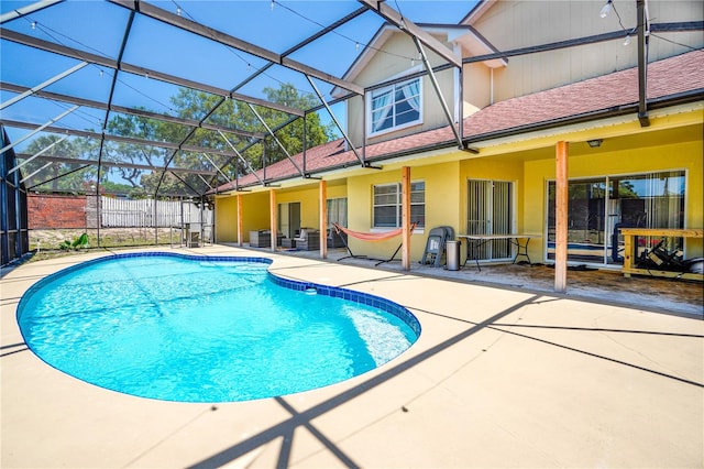 view of pool featuring a lanai, a patio, a fenced in pool, and fence