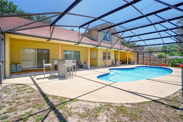view of swimming pool with a patio area, a fenced in pool, fence, and glass enclosure