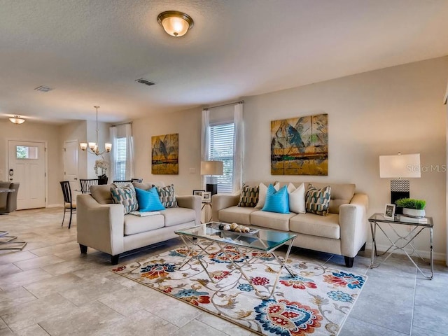 1550 Dalehurst Ln, Kissimmee, FL 34744 - living room with visible vents, baseboards, and an inviting chandelier