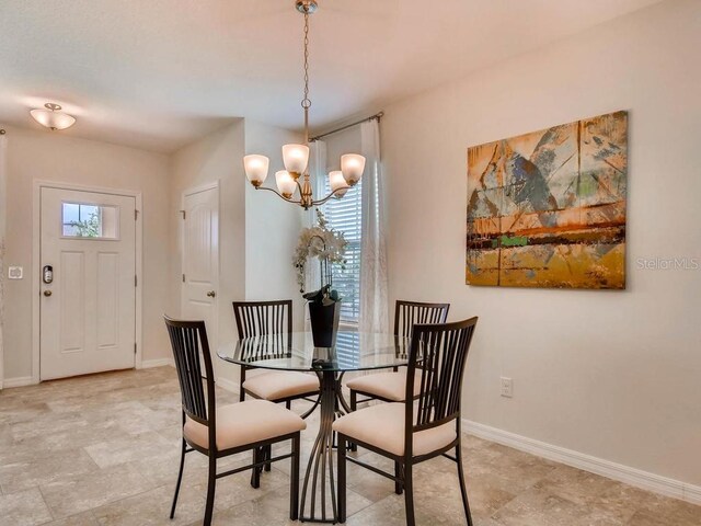 1550 Dalehurst Ln, Kissimmee, FL 34744 - dining area featuring a chandelier and baseboards