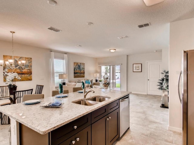 1550 Dalehurst Ln, Kissimmee, FL 34744 - kitchen featuring a sink, visible vents, appliances with stainless steel finishes, and a chandelier