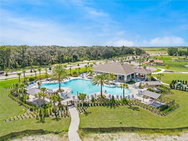 1550 Dalehurst Ln, Kissimmee, FL 34744 - community pool featuring a patio, fence, and a lawn