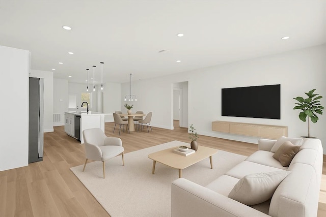 living area with light wood-type flooring, recessed lighting, and baseboards