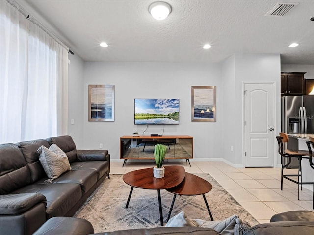 2432 Tangier Dr, Kissimmee, FL 34747 - living area with recessed lighting, light tile patterned floors, visible vents, and baseboards