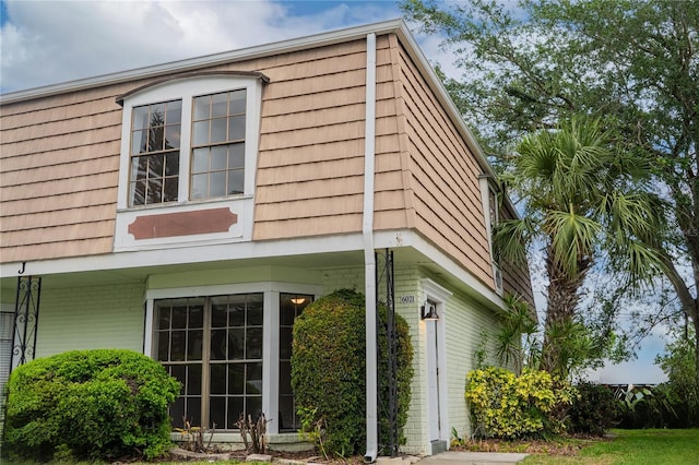 6021 Village Cir Unit 6021, Orlando, FL 32822 - view of property exterior with brick siding and mansard roof
