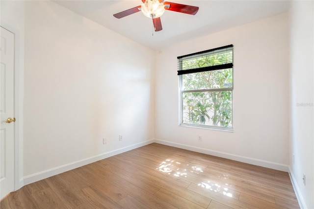 empty room with light wood-style flooring, ceiling fan, and baseboards