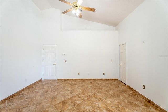 empty room with high vaulted ceiling and a ceiling fan