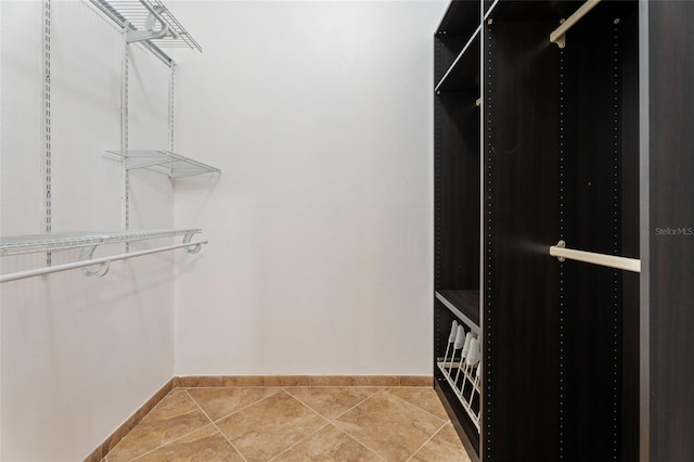 walk in closet with tile patterned flooring