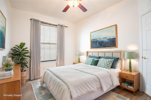bedroom with light wood finished floors and a ceiling fan