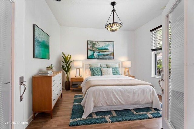 bedroom with wood finished floors and baseboards