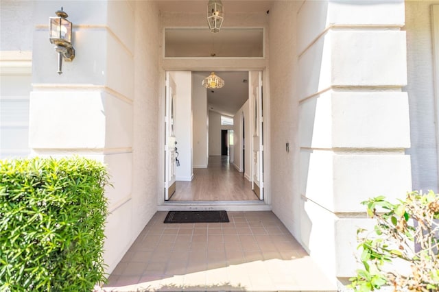 view of exterior entry with stucco siding