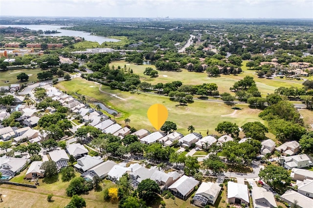 aerial perspective of suburban area with a nearby body of water and a local golf course