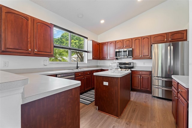 7264 Hawksnest Blvd, Orlando, FL 32835 - kitchen featuring appliances with stainless steel finishes, lofted ceiling, light countertops, light wood-style flooring, and recessed lighting
