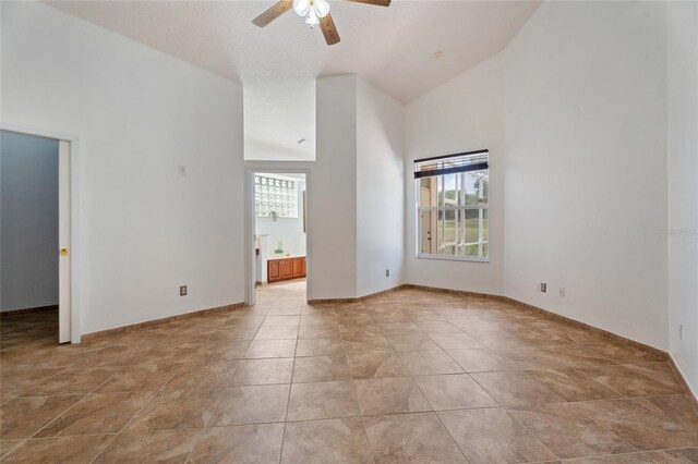 7264 Hawksnest Blvd, Orlando, FL 32835 - spare room featuring plenty of natural light, high vaulted ceiling, and ceiling fan