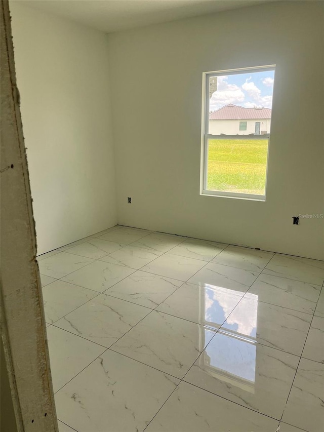 24462 Cabana Rd, Punta Gorda, FL 33955 - empty room with light marble finish flooring