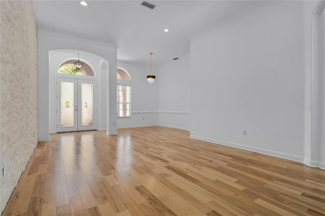 1803 Glenbay Ct, Windermere, FL 34786 - foyer entrance featuring visible vents, crown molding, french doors, arched walkways, and light wood finished floors