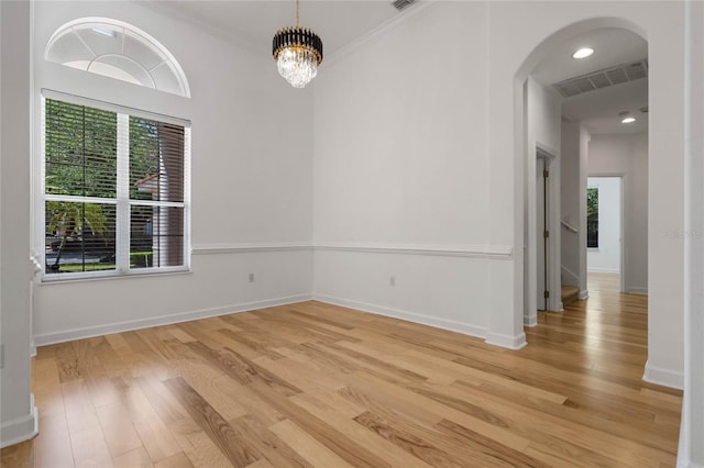 1803 Glenbay Ct, Windermere, FL 34786 - empty room featuring arched walkways, visible vents, a wealth of natural light, and light wood-style flooring
