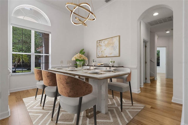 1803 Glenbay Ct, Windermere, FL 34786 - dining room with arched walkways, visible vents, a wealth of natural light, and light wood-type flooring