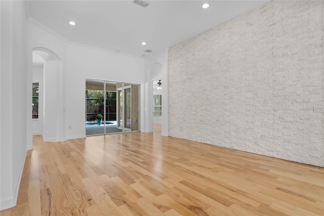 1803 Glenbay Ct, Windermere, FL 34786 - spare room with recessed lighting, arched walkways, a high ceiling, and wood finished floors