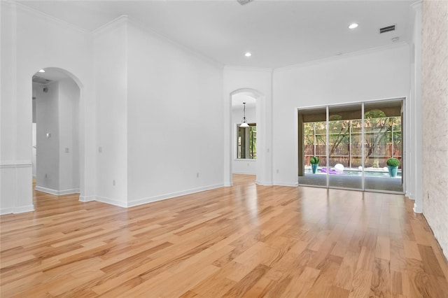 1803 Glenbay Ct, Windermere, FL 34786 - unfurnished room featuring visible vents, arched walkways, ornamental molding, recessed lighting, and light wood-style flooring