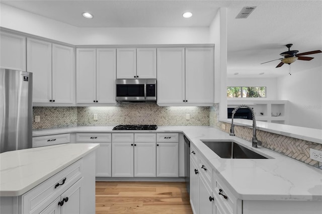 1803 Glenbay Ct, Windermere, FL 34786 - kitchen featuring a sink, a peninsula, tasteful backsplash, and stainless steel appliances