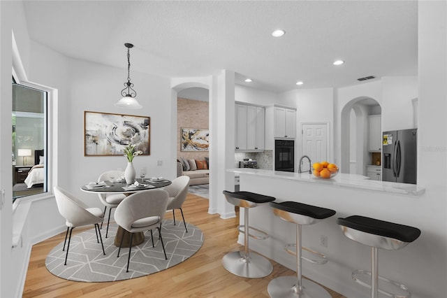 1803 Glenbay Ct, Windermere, FL 34786 - dining room with visible vents, baseboards, light wood-type flooring, recessed lighting, and arched walkways