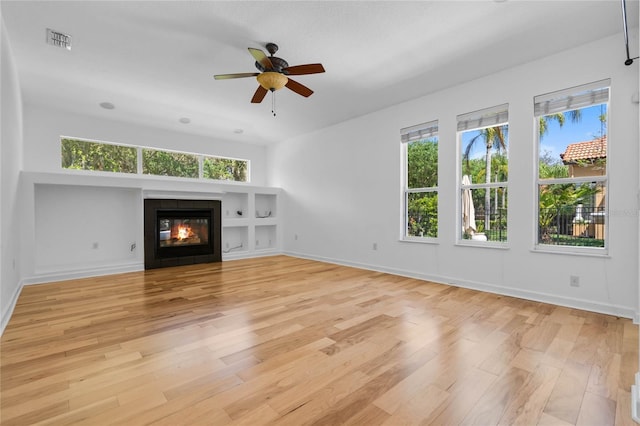 1803 Glenbay Ct, Windermere, FL 34786 - unfurnished living room featuring ceiling fan, visible vents, light wood-type flooring, a tile fireplace, and baseboards