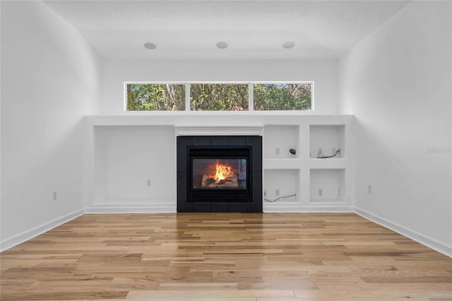 1803 Glenbay Ct, Windermere, FL 34786 - interior space featuring baseboards, built in shelves, wood finished floors, and a fireplace